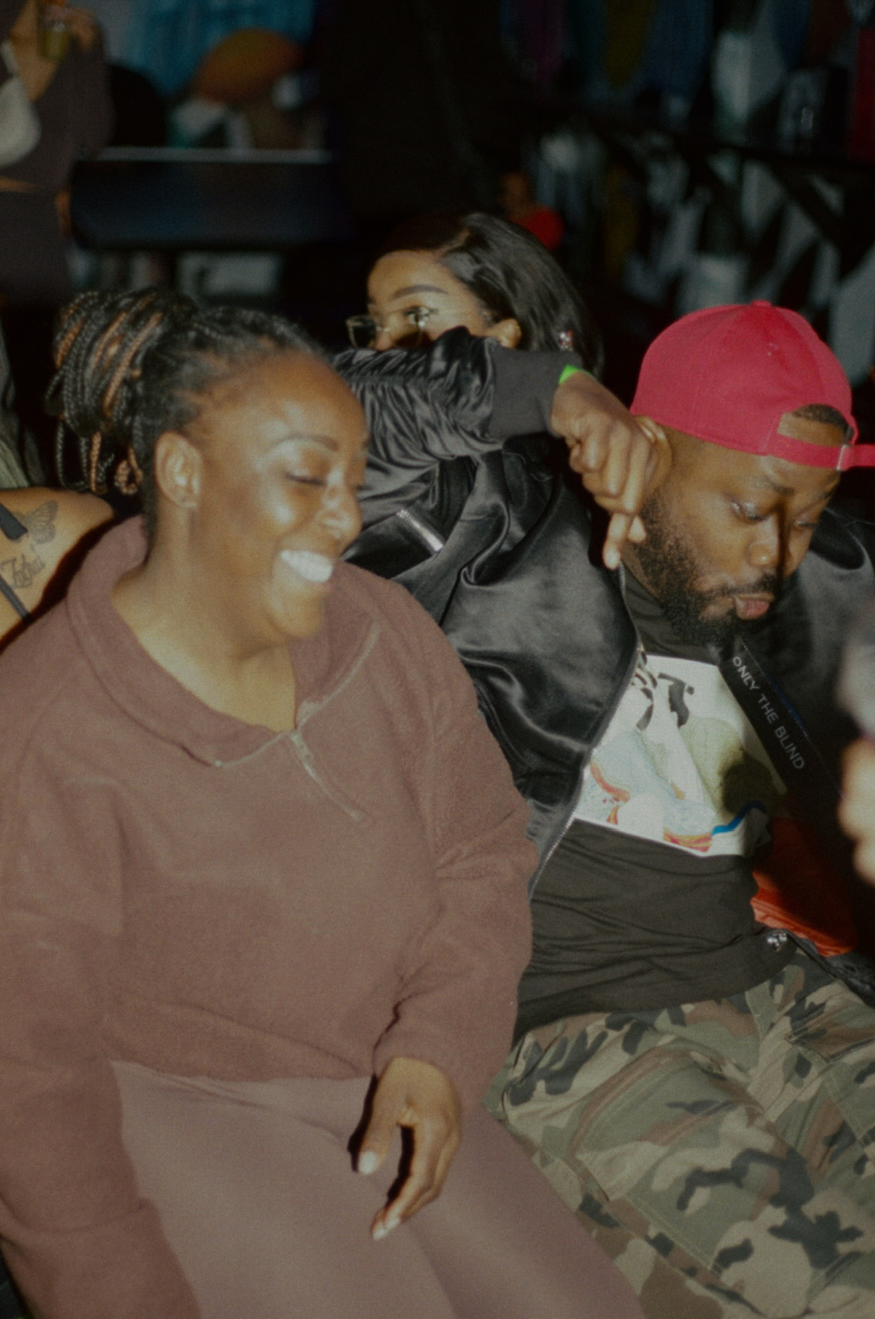 Friends doubled over laughing on a sofa